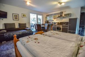 a living room with two beds and a kitchen at Appartement Haus Schröder in Söll