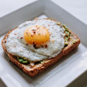 a fried egg on a piece of bread in a box at Hotel Sterling Inn, New Delhi in New Delhi