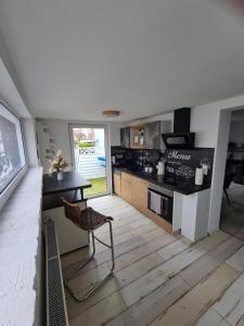 a kitchen with a table and a chair in a room at Möwenstübchen in Zingst