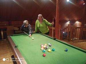 a man and a woman playing a game of pool at Kedros Village in Karpenision
