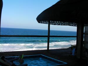una piscina en la playa con sombrilla en Mozambique,Inhambane,Barra -Entire Beach House, en Inhambane