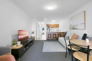 a living room with a couch and a table at 'Little Mermaid' beach apartment best location walk to beach and restaurants - sleeps 4 in Gold Coast