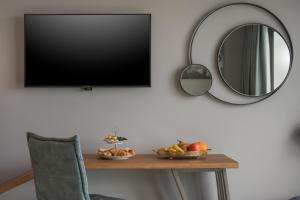 a table with a bowl of fruit and a mirror at Blue Elephant Boutique Hotel & Spa - Adults Only in Almyrida