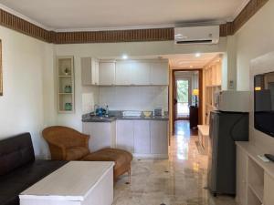 a room with a kitchen and a living room at Coastal Suite at Jayakarta Residence in Seminyak