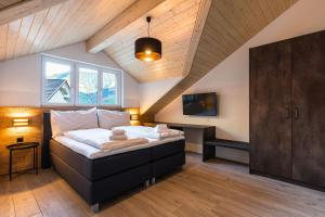 a bedroom with a bed in a attic at Melchtal Resort Apart Hotel in Melchtal