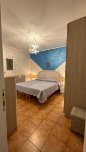 a bedroom with a bed and a chandelier at Apartaments Marina del Cavallino in Cavallino-Treporti +52 photos