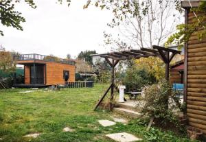 a backyard with a wooden pergola and a bench at İstanbul Airport Bungalow With Terrace in Arnavutköy