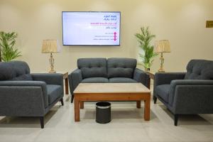 a waiting room with two chairs and a tv at ابات بارك Abat Park in Al Baha