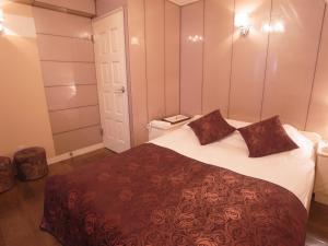 a bedroom with a large bed with two pillows on it at SKYROAD Adult Only in Tokyo +14 photos