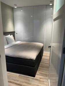 a bedroom with a bed and a sliding glass door at B&B In de Schulp, retreat into your shell in Amstelveen