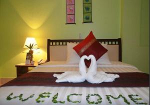 two swans made out of towels on a bed at Parklane Hotel in Siem Reap