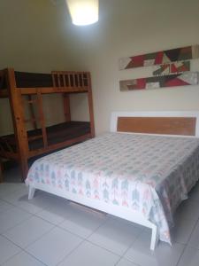 a bedroom with a bed and a wooden crib at Apartamento Condomínio Porto Bracuhy in Angra dos Reis
