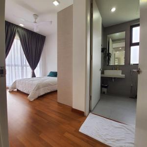 a bedroom with a bed and a sink and a mirror at The Glass Homestay Putrajaya in Putrajaya