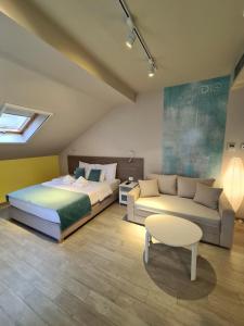 Garni Hotel D10 في بلغراد: غرفة نوم بسرير واريكة وطاولة