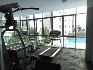 a gym with a swimming pool in a building at Cats' Kingdom SOHO-Dpulze Cyberjaya, Fit 5pax in Cyberjaya
