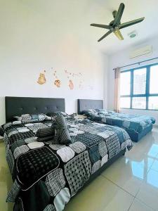 a bedroom with two beds and a ceiling fan at Cats' Kingdom SOHO-Dpulze Cyberjaya, Fit 5pax in Cyberjaya