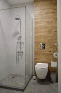 a bathroom with a glass shower with a toilet at Тузлата пентхаус / Tuzlata penthouse in Balchik +6 photos
