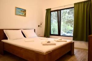 a bedroom with a large bed with a window at Тузлата пентхаус / Tuzlata penthouse in Balchik