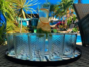 three glasses sitting on a tray on a table at Casa Babalahy in Saint-Pierre