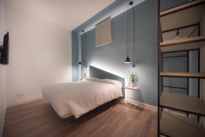 a bedroom with a bed and a dresser at Apuntadores 8 in Palma de Mallorca