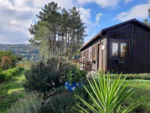 a small cabin in a garden with plants at Casinha do Cedro in Baião