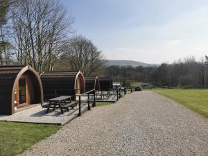 a row of picnic tables and benches in a park at Wyreside Lakes Glamping Pods in Lancaster