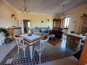 a living room with a table and chairs at Amaranto99 in LʼAquila