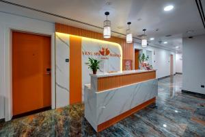 a lobby of a restaurant with an orange wall at Wescott Hotel in Dubai