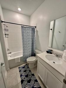 een badkamer met een wastafel, een toilet en een douche bij Grand Family Deluxe 4BR House near Disney Parks in Davenport