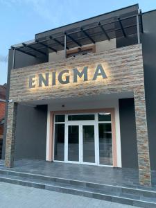 a entrance to a building with a sign on it at Sobe Enigma in Bajina Bašta