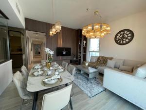 a living room with a table and a couch at Smart Living Apartment in Abu Dhabi