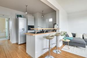 a kitchen and living room with a counter and a refrigerator at New ! Cosy Apt, ideal couple centre de Boulogne in Boulogne-Billancourt