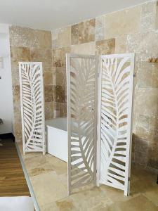 a bathroom with two mirrors and a bath tub at Enzo Hotels Limoges Centre Jourdan by Kyriad Direct in Limoges