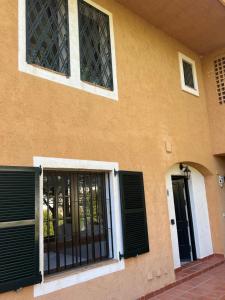 a building with black shutters on the side of it at Luxury Apartments Mascarat in Altea