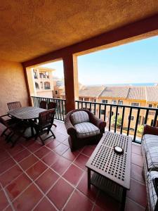 a patio with a table and chairs on a balcony at Luxury Apartments Mascarat in Altea