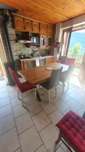 a kitchen with a wooden table and chairs at Le chalet de Flo in Séez
