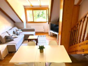 a living room with two tables and a couch at Arriel 28:24 in Escarrilla