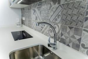 a kitchen with a sink and a faucet at SAN ANDRÉS 13 in Torre del Mar +99 photos