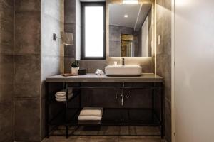 a bathroom with a sink and a mirror at Urban Rooms by NEU Collective in Il-Gżira