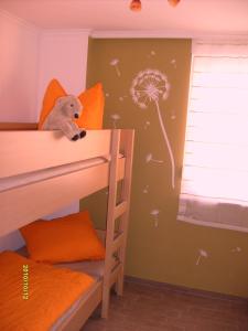 a bedroom with a bunk bed with a dandelion wall at Apartment zum Dünenblick in Trassenheide