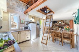 a kitchen with a ladder in the middle of a kitchen at Holiday Home Gabelot in Supetar