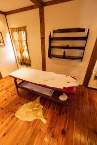 a bed in a room with a wooden floor at ETNO SELO VRANEŠA Zlatar in Nova Varoš