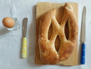 a loaf of bread and an egg on a cutting board at À l'orée du Cagire in Juzet-dʼIzaut