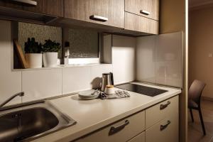 a kitchen with a sink and a counter top at 115 The Strand Hotel by NEU Collective in Il-Gżira