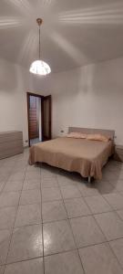 a bedroom with a bed and a light on the ceiling at Niguarda Alfred House in Bresso