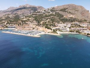 an aerial view of a resort on a hill with blue water at Luxury Apartments Mascarat in Altea