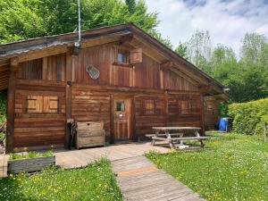 a log cabin with a picnic table in front of it at Chalet Cocoon vue MontBlanc in Saint-Gervais-les-Bains
