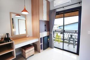 a kitchen with a large window and a balcony at Avarin Resort in Pak Chong