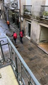 a group of people walking down a street at Casa dos Cantares in Padrón