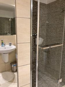 a bathroom with a shower and a sink at Apartament Patio 50 m od plaży in Władysławowo +26 photos